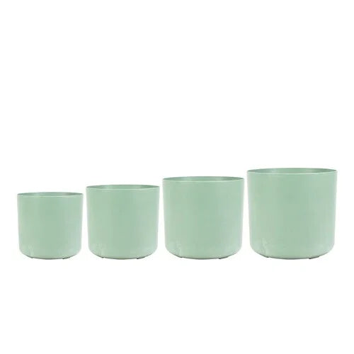 Four light green recycled polymer pots of varying sizes on a white background