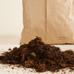 Brown bag of universal potting mix sustainably made in the EU on a light background