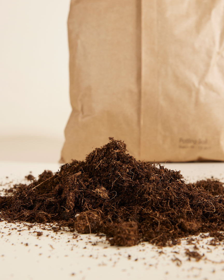 Brown bag of universal potting mix sustainably made in the EU on a light background