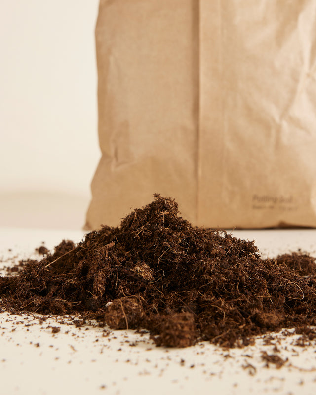 Brown bag of universal potting mix sustainably made in the EU on a light background