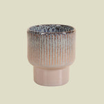 Ceramic houseplant planter with textured design on a white background